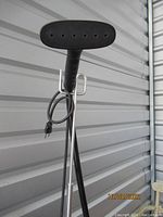 Close-up of Jiffy Steamer handle and part of the pole with attached power cord.
