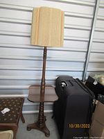 Full view of vintage floor lamp with integrated wooden table, showing turned wood stand and rectangular fabric lampshade with stripes.
