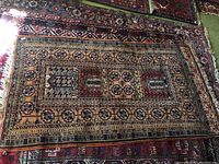 Full view of the hand made carpet showing its overall design and color.