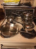 Front view of entire cookware set arranged on stove