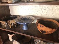 Overall shot of all three Mid Century Modern studio pottery pieces on wooden shelf.