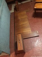 Overall view of wood veneer queen headboard with attached floating side tables laid on floor