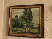 Full view of the framed landscape painting showing trees, grass, and two seated figures