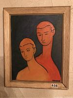 Frontal view of framed painting showing two stylized portrait heads