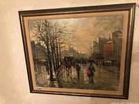 Front view of framed oil painting depicting Paris street scene with horse-drawn carriage and figures with umbrellas