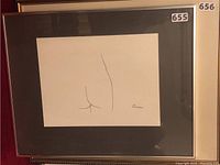 Front view of framed artwork showing black mat and silver frame