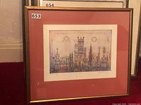 Framed and matted lithograph displayed leaning against wall, shows overall piece