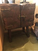 Front view of wooden cabinet showing two doors and iron hardware