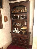 Full front view of two-piece cabinet showing overall form and finish