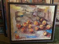 Full view of the original painting depicting oranges with textured brushwork and warm color palette in a wooden frame.