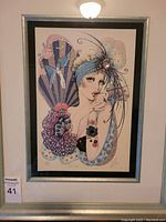 Framed print of a flapper woman decorated with embossed patterns and jewels shown in full frame.