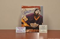 Image showing signed 8x10 photo of Rogie Vachon in Los Angeles Kings goalie mask and jersey. Photo is autographed in blue ink. Included are two certificates: one certificate of authenticity and one Sport Card Expo autograph ticket.