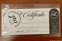 Photo of $25 gift certificate for Hay Bay Fine Foods and Catering Services, showing branding and certificate details.