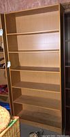 Front view of the MDF bookshelf with six shelves and visible shelf holders, showing overall structure and size.