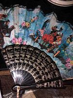Decorative hand fan with painted dancing figures and floral motifs