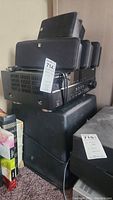 Stacked Boston Acoustics speakers and Yamaha receiver with visible tags and cables.