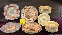 Stacked sets of Spode luncheon plates (Kashmir and Archive Collection) and Royal Doulton Stratford bread plates and saucers, showing pattern variety and sizes