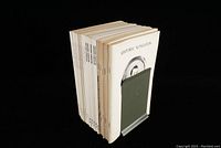 Side view showing 18 stacked issues of Historic Kingston magazine in white paper covers.