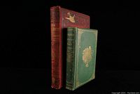 Two antique natural history books upright on black background, showing front and spine with decorative cloth covers and titles.