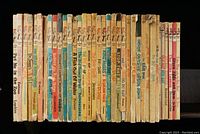 Photo showing spines of 36 vintage children's books, 20 are Dr. Seuss titles with vintage wear and edge damage.