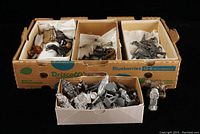 Cardboard produce box with four compartments filled with mixed metal figures, horses and a small tray of vehicles and accessories