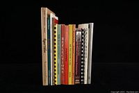 Side view of 15 assorted local history books from Hastings County and area, showing various titles and colors