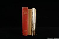 Five Kingston local history books upright showing spines and covers, including a red hardcover and several softcover books.