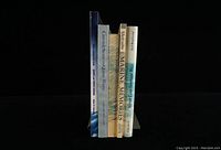 Side view of 5 books showing spines and titles related to Prince Edward County and marine topics.