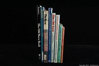 Front view of 8 books standing upright, showing titles related to barns, watermills, Ontario houses, and more.