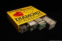 Yellow Electro-Voice box front view with black text and red heart graphic, showing the compartments of needles packed inside.