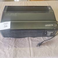 Full view of Oreck XL Professional Air Purifier unit showing front and top vents, logo, and power cord.