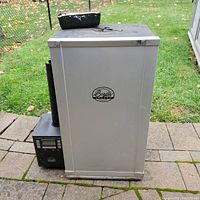 Full front view of smoker cabinet and attached digital smoke generator module