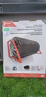 Photo of the unopened boxed Richelieu heavy-duty wall mount tire storage rack, showing the product image with multiple tires stored horizontally on the rack.