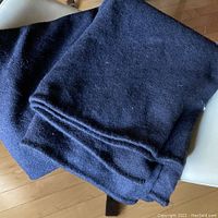 Photo showing the folded midnight blue wool blanket, highlighting texture and color.