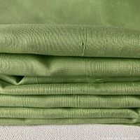 Folded apple green silk fabric showing texture and weave