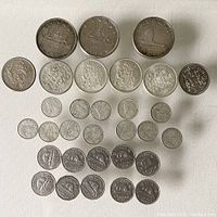 Overview of all Canadian coins in lot laid out on white surface.