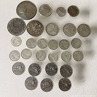 Full view of all coins arranged in several rows showing various denominations and years.