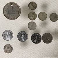 Top view of Canadian coins from 1939 silver dollar, multiple dimes 1942, 1943, 1947, nickels 1944, 1945, and 1947 Newfoundland 10 cents