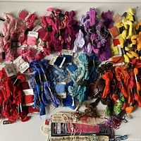Full lot of cotton embroidery thread organized by color including reds, pinks, blues, purples, yellows, oranges and browns.