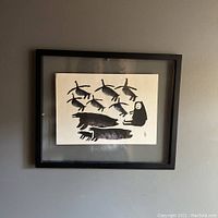 Front view of framed print hanging on wall