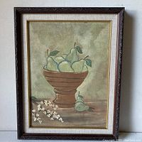 Full view of the framed original painting showing pears in a brown pedestal bowl with white flowers on the table beneath, featuring a muted color palette.