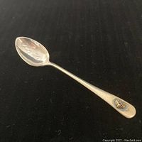 Photo of the front side of spoon showing the White Horse inscription inside the bowl and gold nugget at end of handle.