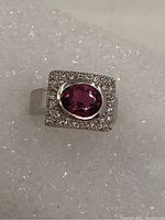 Top view of ring showing square head with oval pink tourmaline center and surrounding diamonds
