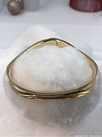 Front view of bangle showing triangular curved profile