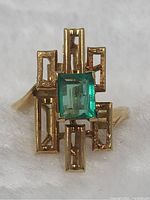 Top view showing rectangular emerald and surrounding openwork gold setting
