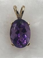 Front view showing oval faceted amethyst in prong setting