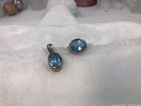 Both pendant and ring displayed on white background