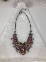 Full view of multicolor glass and metal bib necklace displayed on white background
