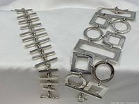 Both bracelets displayed on white fabric background