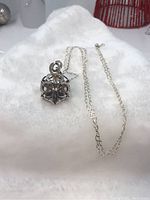 Full view of pendant necklace with chain on white background